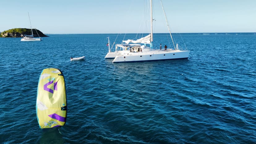 Kitesurfer jumping waves Antigua luxury catamaran kitesurfing kite safari