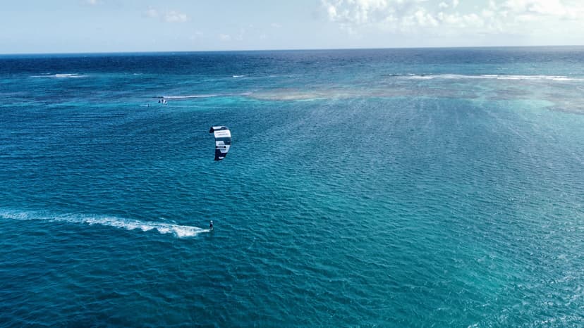 Kitesurfer jumping waves Antigua luxury kite safari Caribbean catamaran kitesurfing